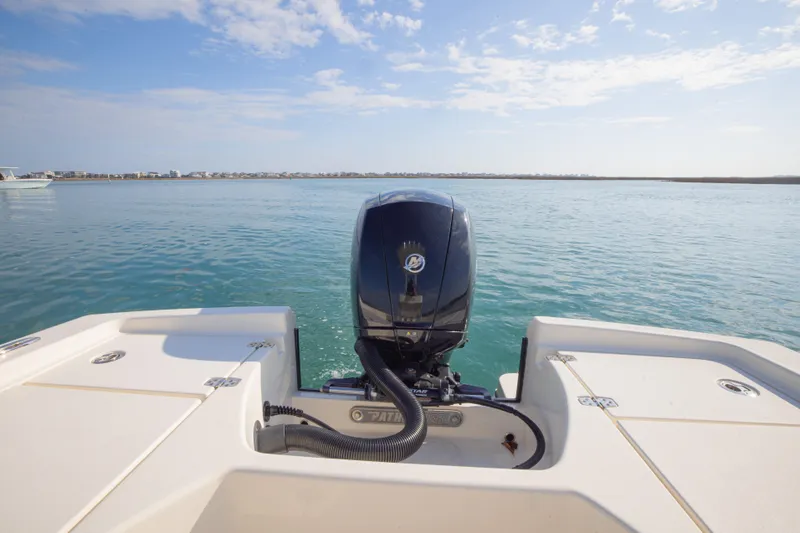 Slide: The Image of Pathfinder 2005 TRS boat engine on calm water, clear sky, 2022 model. - 21