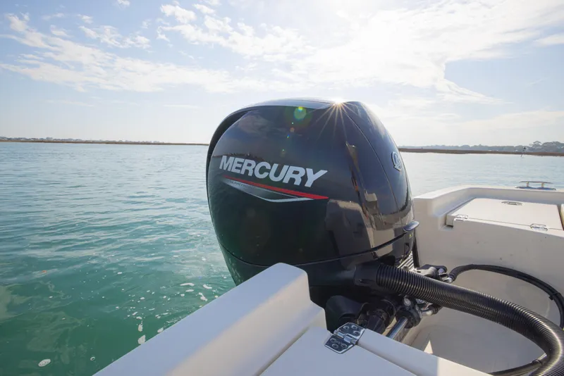 Slide: The Image of Outboard motor on 2022 Pathfinder 2005 TRS boat, cruising on calm waters. - 22