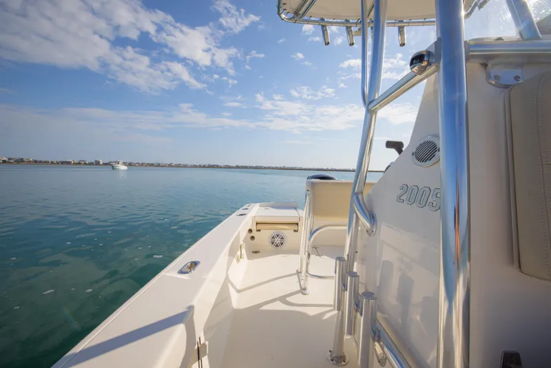 Slide: The Image of Pathfinder 2005 TRS boat on calm water under a clear blue sky, 2022 model. - 26