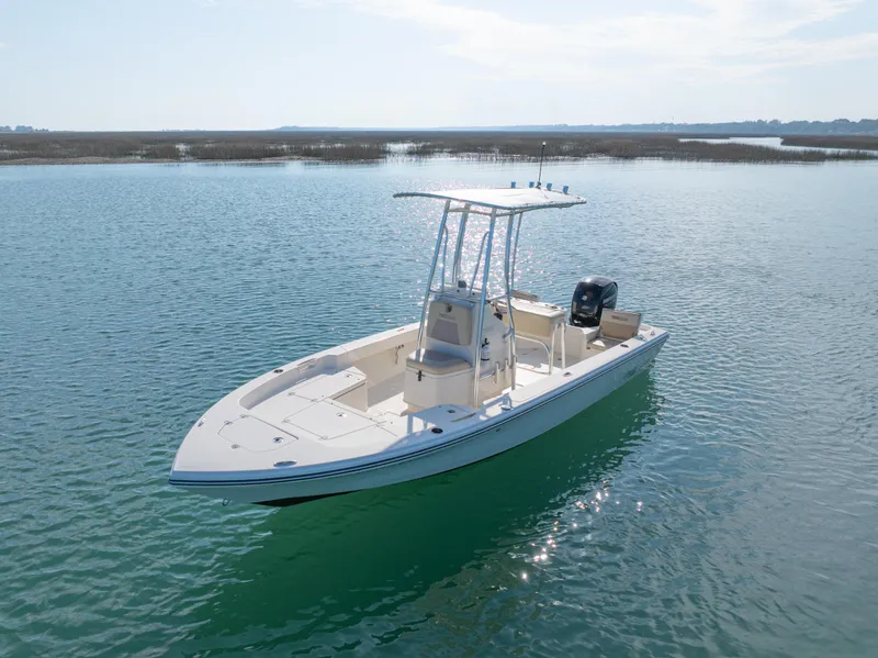 Slide: The Image of Pathfinder 2005 TRS boat on calm water, 2022 model, with T-top and outboard motor. - 3