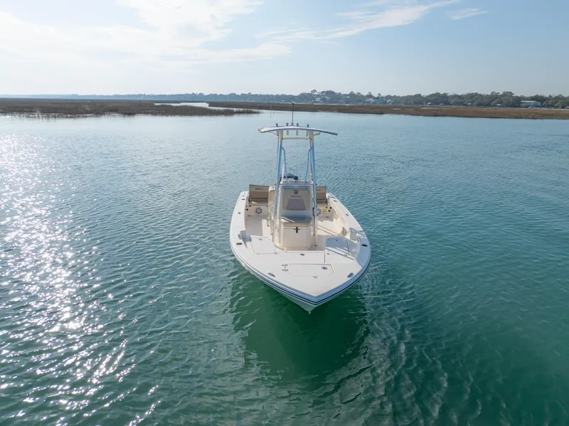 Slide: The Image of Pathfinder 2005 TRS boat on calm water, 2022 model, under a clear sky. - 4