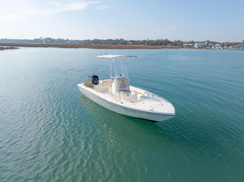 Slide: The Image of A 2022 Pathfinder 2005 TRS boat on calm blue water under a clear sky. - 5