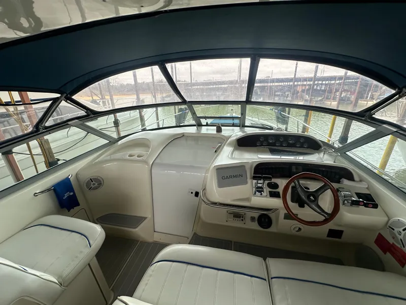 Slide: The Image of 1996 Sea Ray 330 Sundancer helm with steering wheel and navigation equipment. - 15