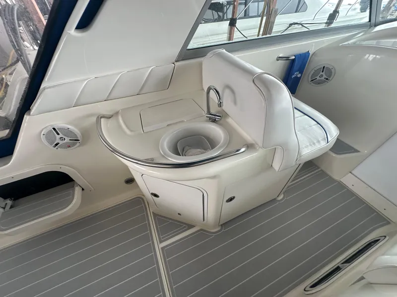 Slide: The Image of 1996 Sea Ray 330 Sundancer interior with sink and seating area. - 16