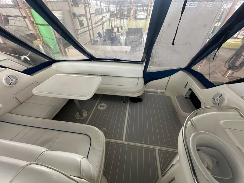 Slide: The Image of 1996 Sea Ray 330 Sundancer interior with seating and table, enclosed by clear panels. - 17