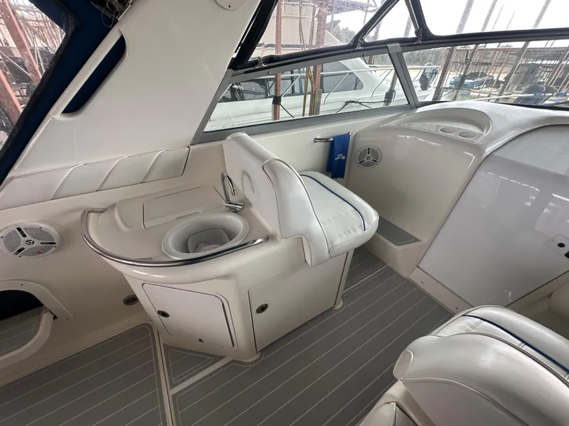 Slide: The Image of 1996 Sea Ray 330 Sundancer interior with white seating and helm station. - 18