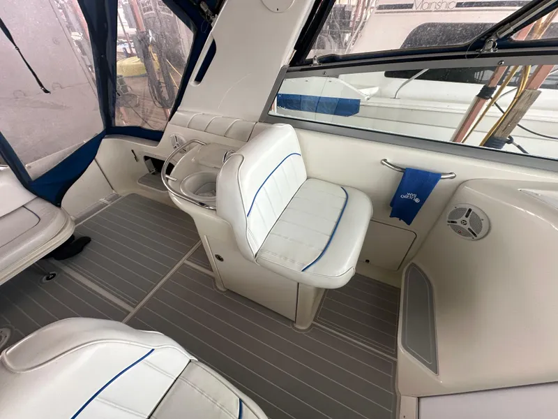 Slide: The Image of Interior of a 1996 Sea Ray 330 Sundancer boat with white seating and blue accents. - 19