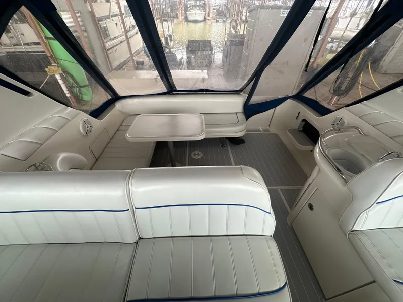 Slide: The Image of Interior of a 1996 Sea Ray 330 Sundancer with white seating and a table. - 20