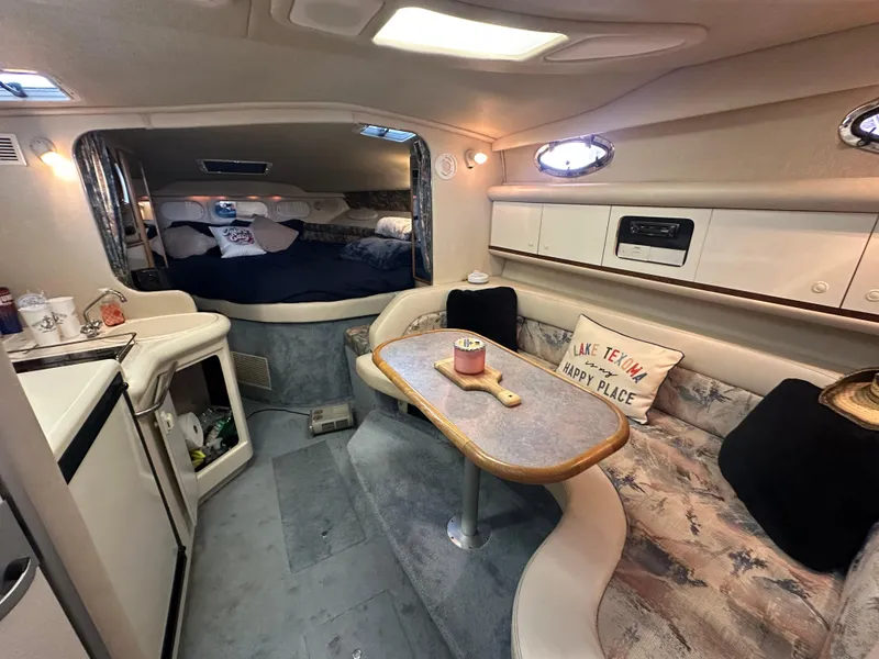 Slide: The Image of Interior of 1996 Sea Ray 330 Sundancer yacht with cozy seating and dining area. - 23