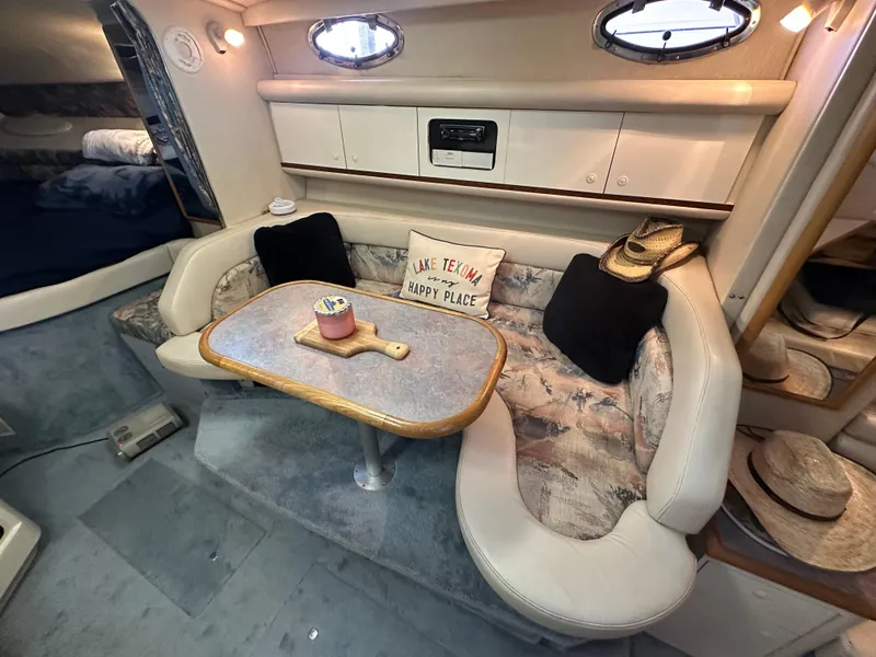 Slide: The Image of 1996 Sea Ray 330 Sundancer cabin with cozy seating and decorative pillows. - 24