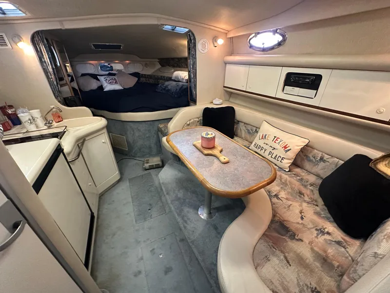 Slide: The Image of Interior of 1996 Sea Ray 330 Sundancer yacht with cozy seating and kitchenette. - 26