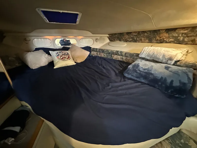 Slide: The Image of Interior cabin of 1996 Sea Ray 330 Sundancer with cozy bedding and pillows. - 29