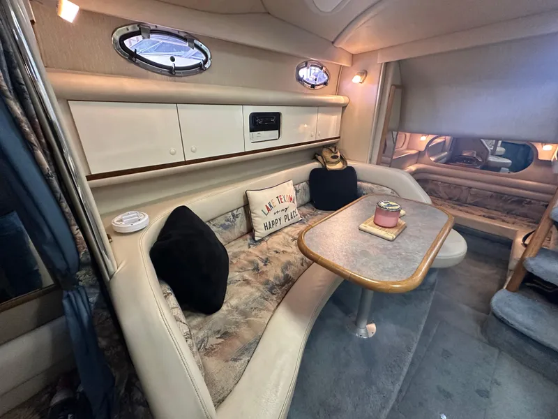 Slide: The Image of Interior of 1996 Sea Ray 330 Sundancer with cozy seating and table setup. - 32