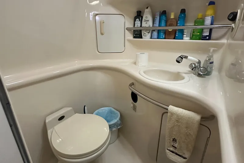 Slide: The Image of Bathroom interior of 1996 Sea Ray 330 Sundancer yacht, featuring sink and toiletries. - 38