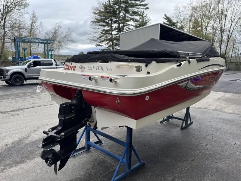 Slide: The Image of 2009 Sea Ray 175 Sport boat on stands, red and white, outdoor setting. - 4