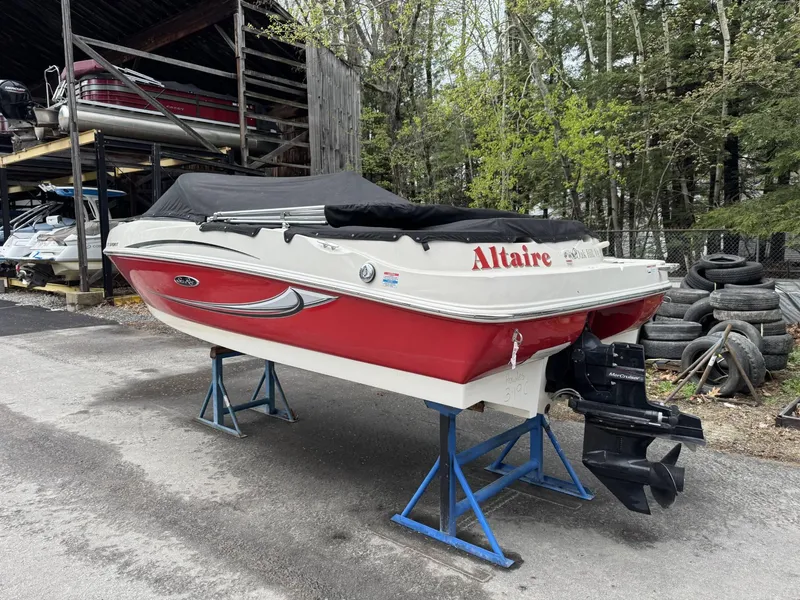 Slide: The Image of 2009 Sea Ray 175 Sport boat on stands, covered, in storage area. - 5