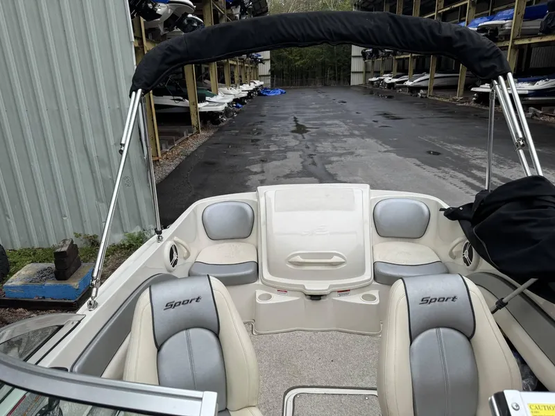 Slide: The Image of 2009 Sea Ray 175 Sport boat interior with seating and canopy in storage facility. - 8