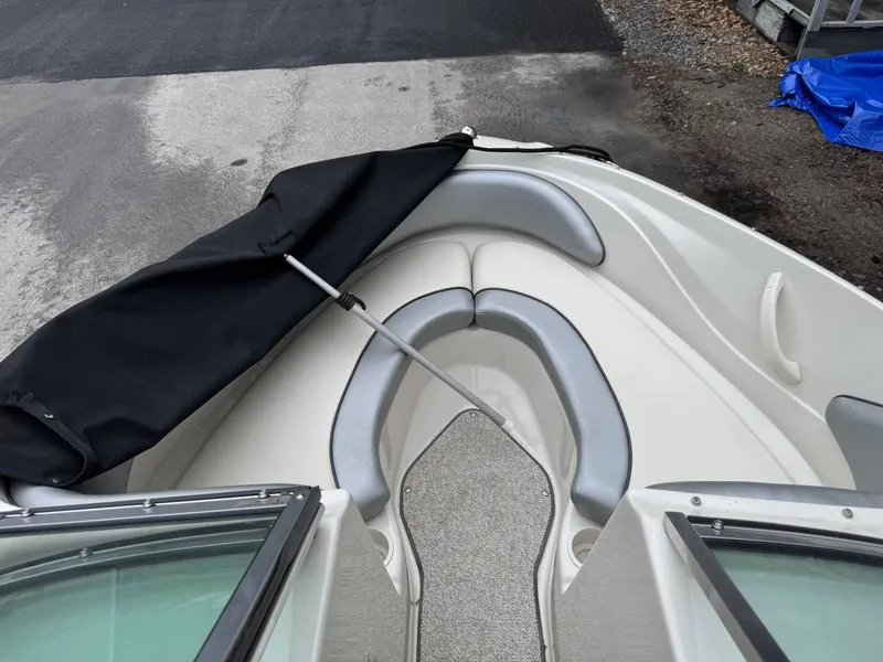 Slide: The Image of 2009 Sea Ray 175 Sport boat interior with gray seating and black cover. - 9