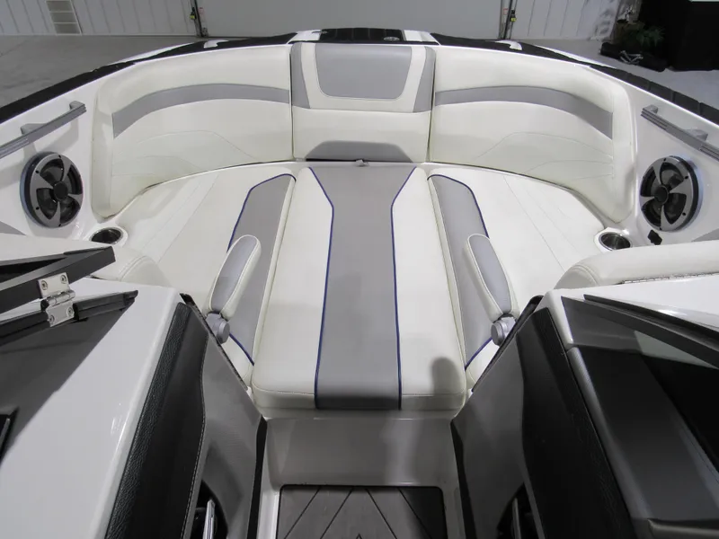 Slide: The Image of 2017 Malibu 22 MXZ boat interior with white and gray seating. - 11
