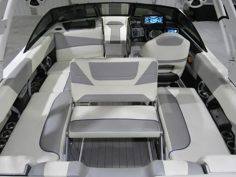 Slide: The Image of 2017 Malibu 22 MXZ boat interior with modern seating and dashboard controls. - 4