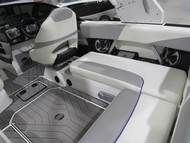 Slide: The Image of 2017 Malibu 22 MXZ interior with gray and white seating, modern dashboard, and sleek design. - 6