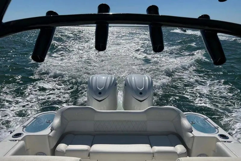 Slide: The Image of 2026 Key West 291 FS boat cruising on open water, featuring dual engines. - 22