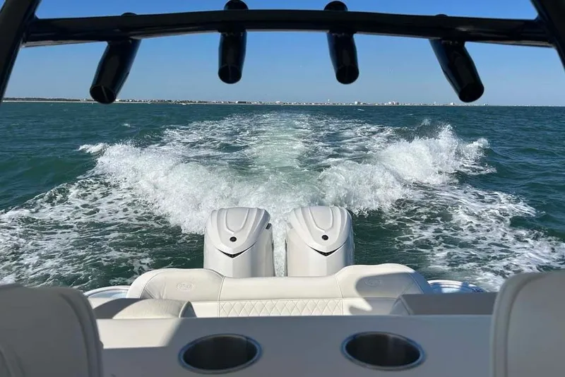 Slide: The Image of 2026 Key West 291 FS boat cruising on open water, leaving a wake behind. - 23