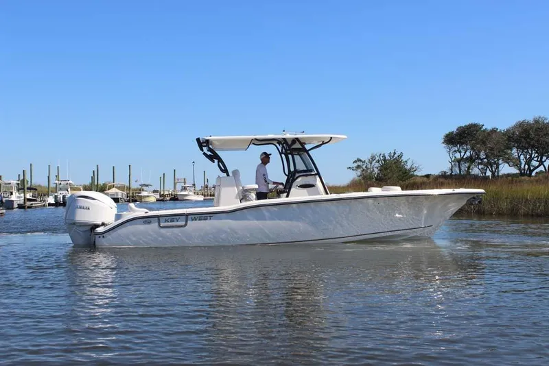 Slide: The Image of 2026 Key West 291 FS boat cruising on calm water under clear blue sky. - 9