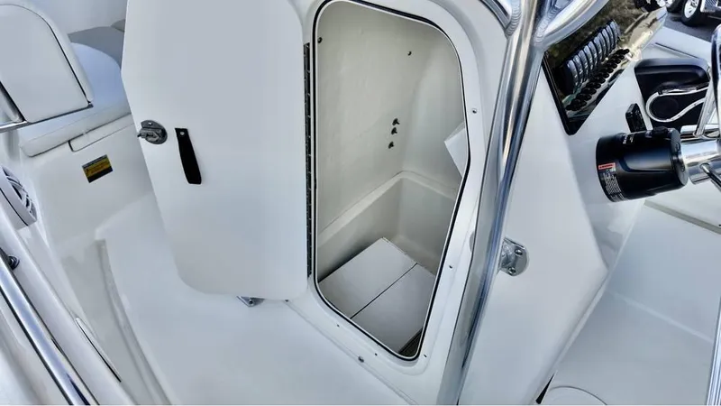 Slide: The Image of 2025 Bulls Bay 200CC boat interior storage compartment with open door. - 17