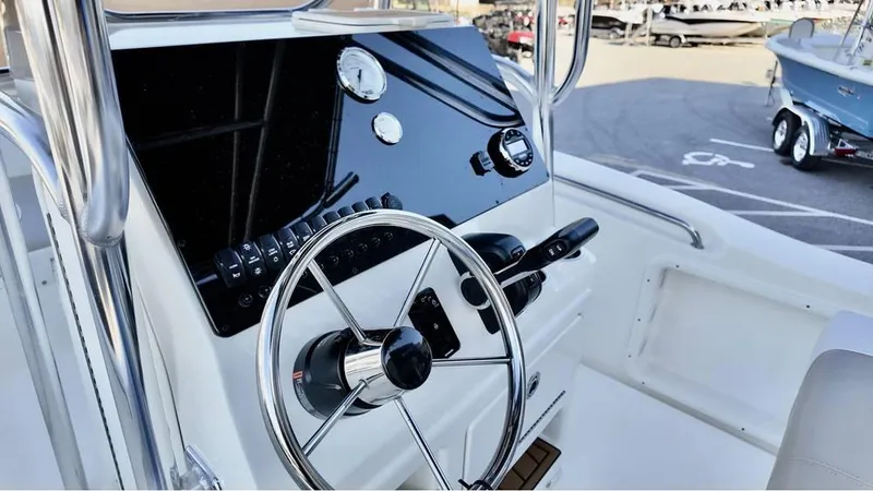 Slide: The Image of 2025 Bulls Bay 200CC boat dashboard with steering wheel and controls. - 18