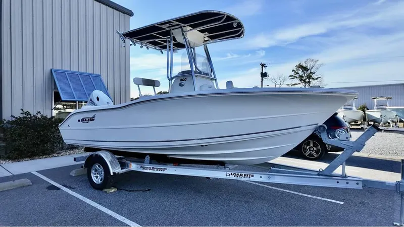Slide: The Image of 2025 Bulls Bay 200CC boat on trailer, parked outdoors near a building. - 7