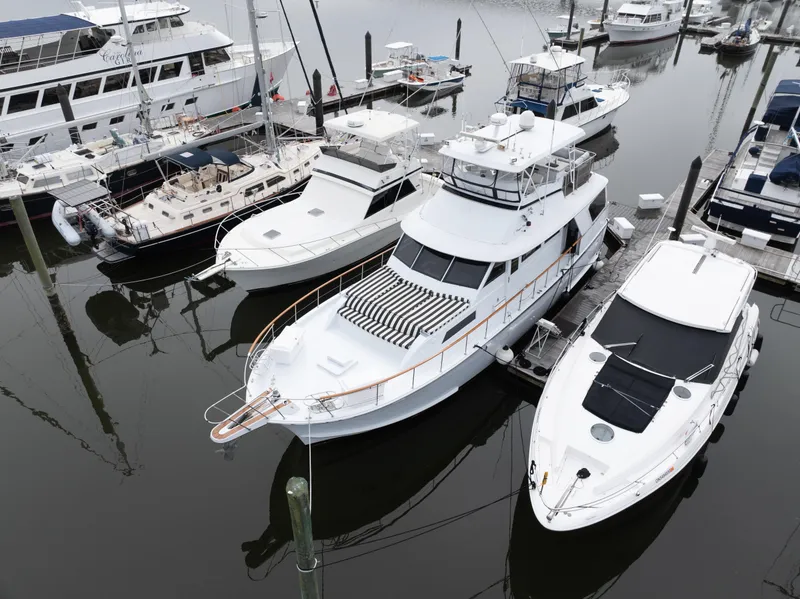 Slide: The Image of 1980 Hatteras 53 Motor Yacht docked among other boats in a marina. - 10