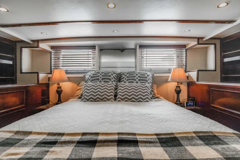 Slide: The Image of Luxurious bedroom interior of 1980 Hatteras 53 Motor Yacht with cozy bedding and elegant lighting. - 12