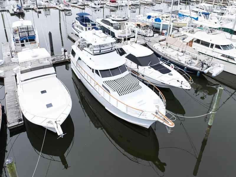 Slide: The Image of 1980 Hatteras 53 Motor Yacht docked among other boats in a marina. - 13