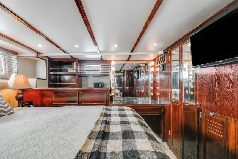 Slide: The Image of Luxurious interior of a 1980 Hatteras 53 Motor Yacht with wood paneling and modern amenities. - 17