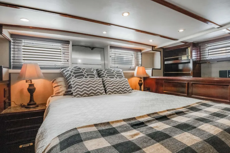 Slide: The Image of Luxurious bedroom interior of 1980 Hatteras 53 Motor Yacht with cozy bedding and ambient lighting. - 20