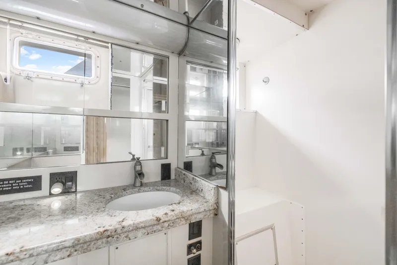 Slide: The Image of 1980 Hatteras 53 Motor Yacht bathroom with granite countertop and mirrored cabinets. - 22