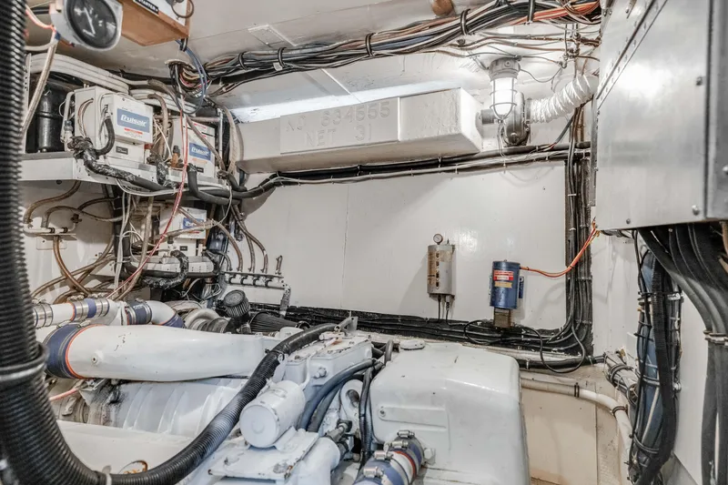 Slide: The Image of Engine room of 1980 Hatteras 53 Motor Yacht with visible wiring and machinery. - 25