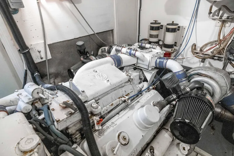 Slide: The Image of Engine room of a 1980 Hatteras 53 Motor Yacht, showcasing mechanical components. - 26