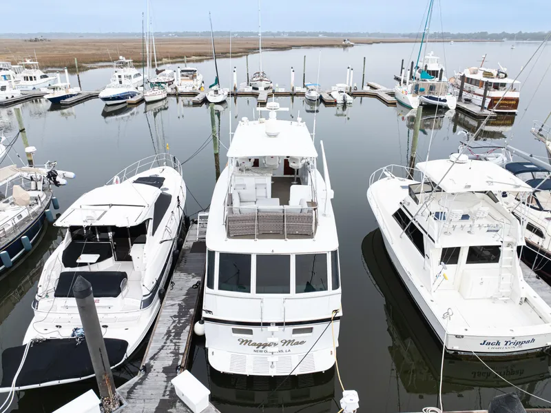 Slide: The Image of 1980 Hatteras 53 Motor Yacht docked in a marina with other boats. - 3