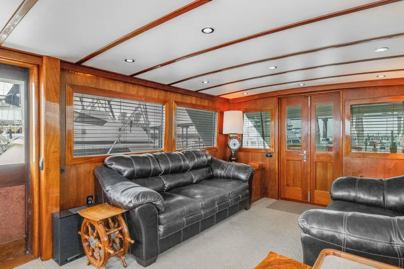 Slide: The Image of Luxurious interior of 1980 Hatteras 53 Motor Yacht with leather sofas and wooden accents. - 37