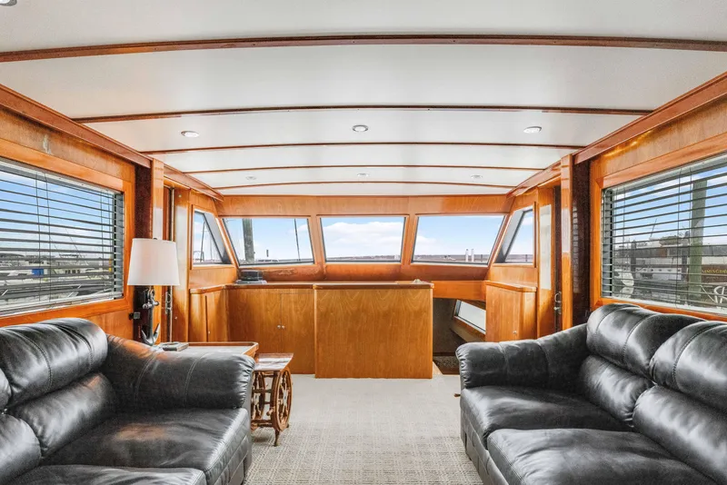 Slide: The Image of Interior of 1980 Hatteras 53 Motor Yacht with leather sofas and panoramic windows. - 38