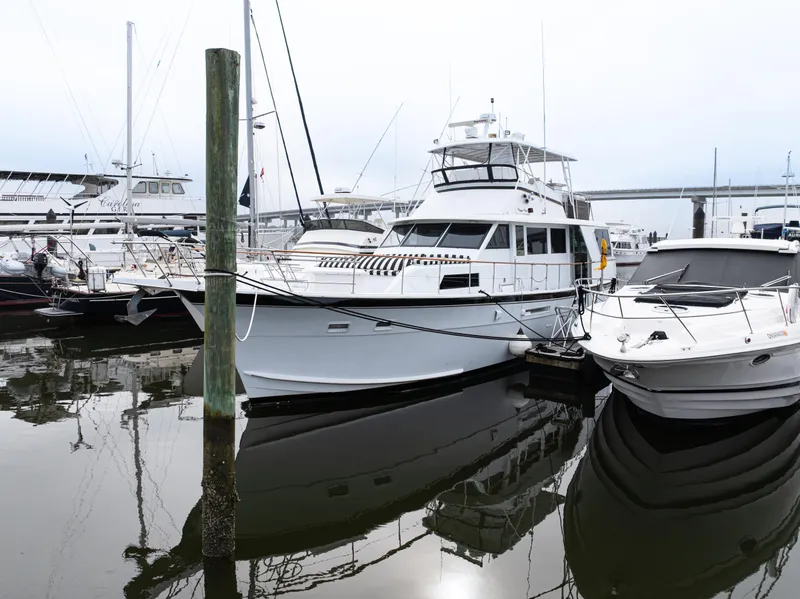Slide: The Image of 1980 Hatteras 53 Motor Yacht docked at marina, surrounded by other boats. - 40