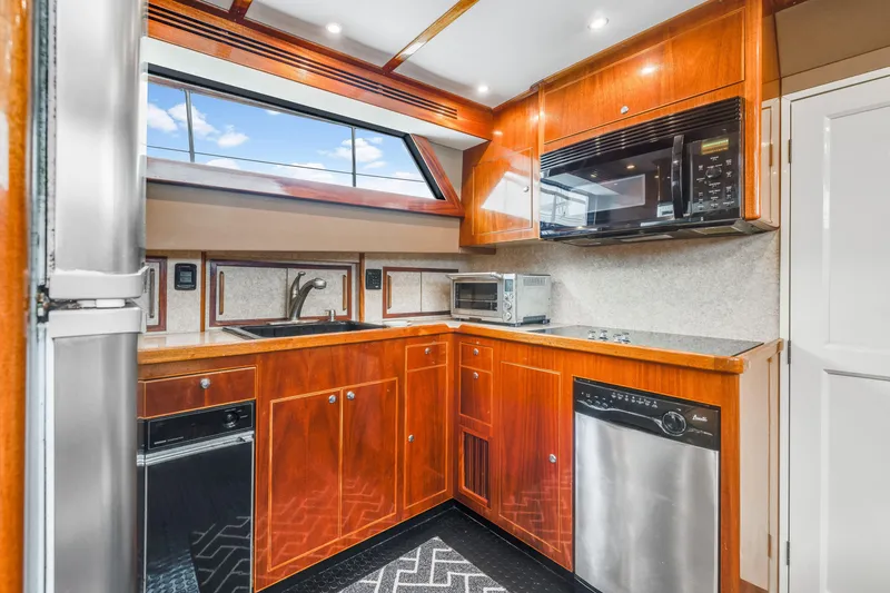 Slide: The Image of Kitchen interior of 1980 Hatteras 53 Motor Yacht with wood cabinetry and modern appliances. - 48
