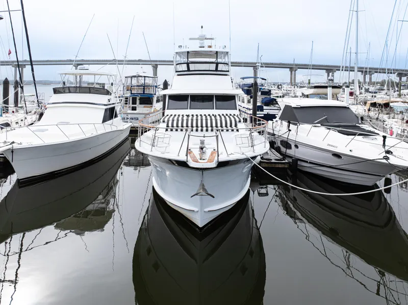 Slide: The Image of 1980 Hatteras 53 Motor Yacht docked among other boats in a marina. - 5