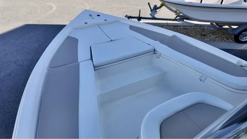 Slide: The Image of 2025 Bulls Bay 2200 XS boat interior with cushioned seating and storage compartments. - 6