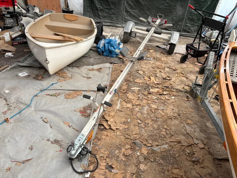 Slide: The Image of 15-ft Adirondack Guideboat from 2012 on a trailer in a workshop setting. - 11