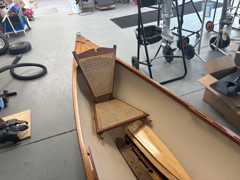 Slide: The Image of 15-ft Adirondack Guideboat, 2012 model, with wooden seat, in a garage setting. - 9