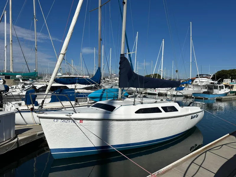 Slide: The Image of 2005 Catalina 250 MkII sailboat docked in a marina under clear blue skies. - 1