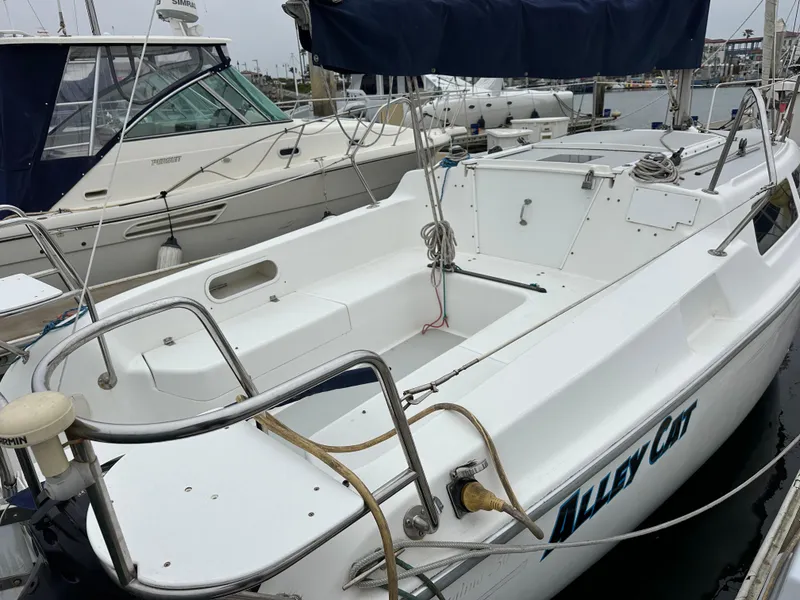 Slide: The Image of 2005 Catalina 250 MkII sailboat docked in marina, featuring spacious cockpit and sleek design. - 13